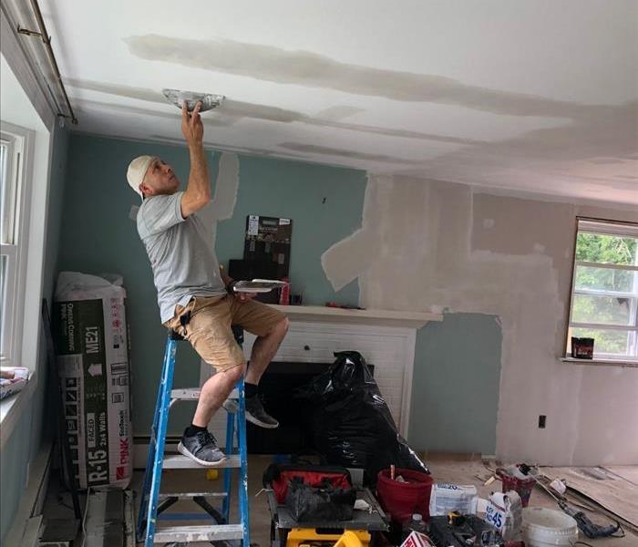 man painting ceiling